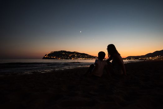 Mother and son at Alanya beach, view from the beach, one of the famous destinations in Turkey.