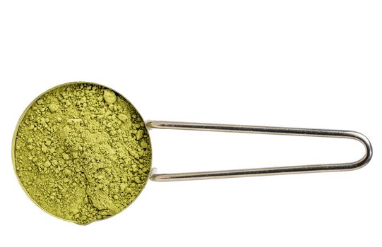 measuring scoop of organic matcha green tea powder isolated on white