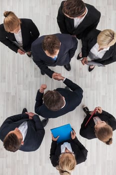 Business people shaking hands, cooperation concept, top view