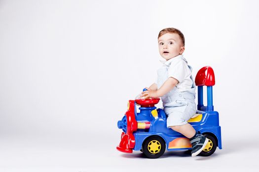 baby boy playing with a toy truck