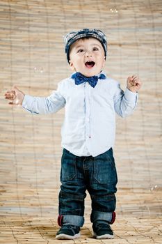 baby boy with gentleman outfit on bamboo background