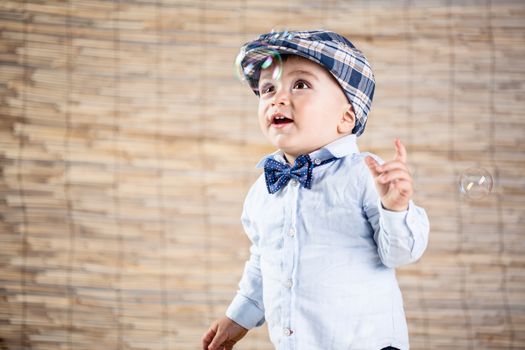 baby boy with gentleman outfit on bamboo background