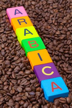 Colored children's cubes and coffee beans - Arabica is the most valuable species of coffee plant, with the most pleasant qualities, representing 59% of world coffee production
