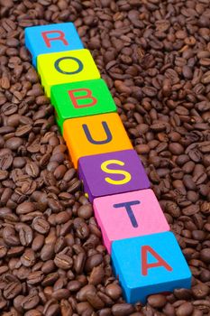 Colored children's cubes and coffee beans - Robusta is a sturdy species of coffee bean with higher acidity and high bitterness