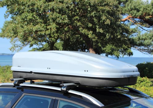 Roof box on car with railing