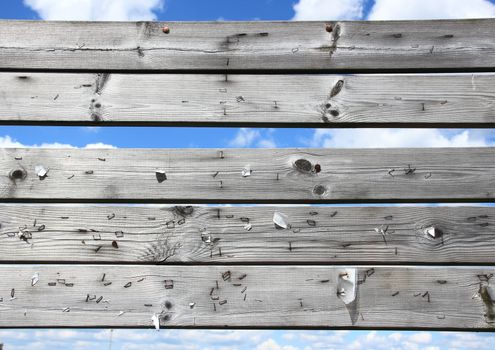 Dashboard of worn planks with rusty staples