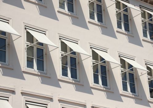 Closeup perspective on grey building with  white awning