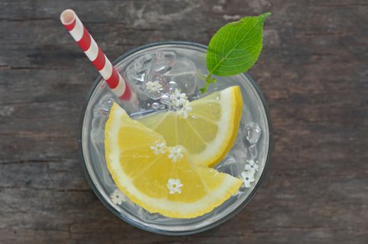 Elder lemonade with ice on old table wood