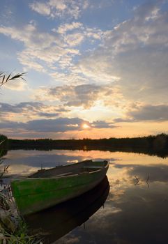 fisherman boat at sunset in summer time