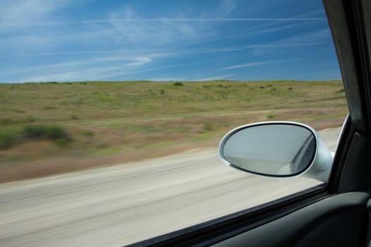 Trying to take a trip this car is moving fast down the road