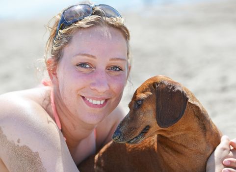 woman and her dog on the beach