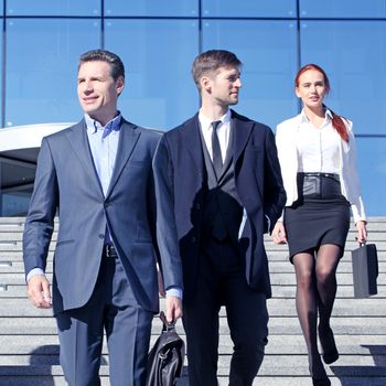 Team of diverse business people at stairs of company office building