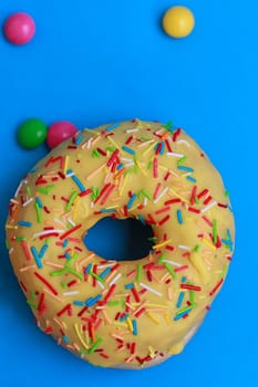 Round Donuts in the glaze on the blue background