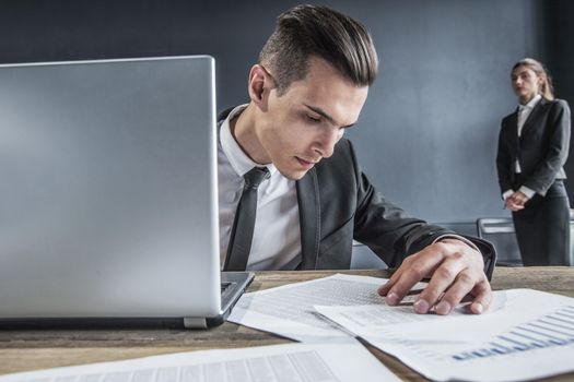 Business man working with laptop computer and documents in office