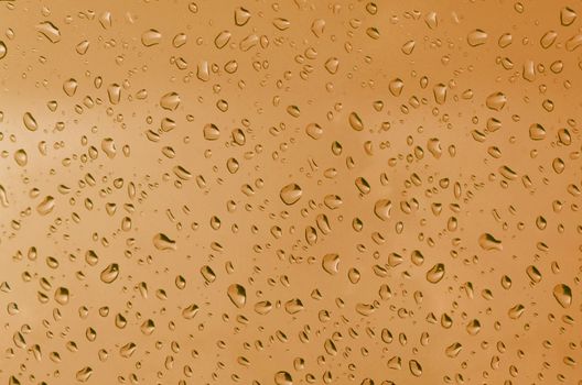 Water droplets on the glass with a colored background. Drops of water.