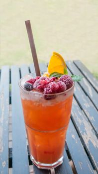 Ice refreshing summer drink with lots of different fruits