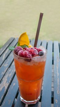 Ice refreshing summer drink with lots of different fruits