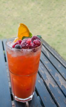 Ice refreshing summer drink with lots of different fruits