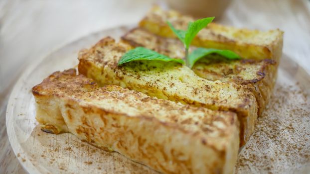 close up cinnamon sugar toast served with sweet sauce