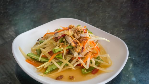 Thai food  spicy papaya salad with pickled brown crab
