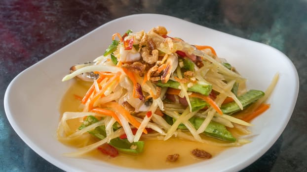 Thai food  spicy papaya salad with pickled brown crab