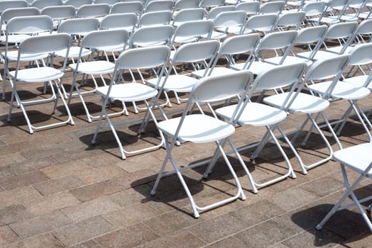 rows of folding chairs at event