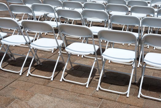 rows of folding chairs at event