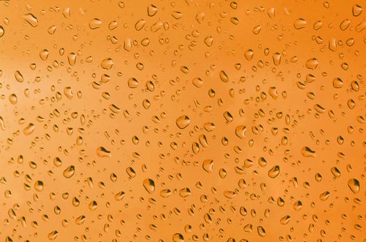 Water droplets on the glass with a colored background. Drops of water.
