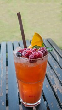 Ice refreshing summer drink with lots of different fruits