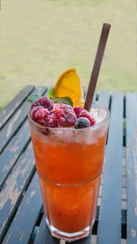 Ice refreshing summer drink with lots of different fruits