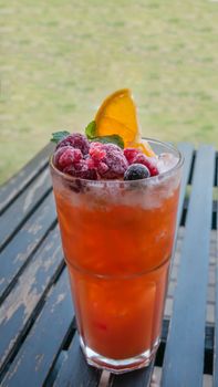 Ice refreshing summer drink with lots of different fruits