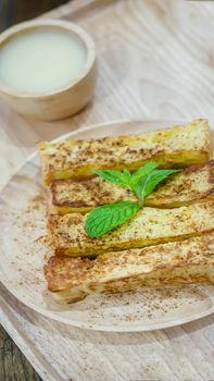 close up cinnamon sugar toast served with sweet sauce