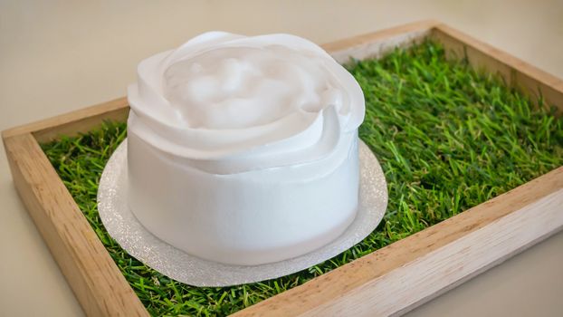 Homemade Coconut cream cake on wooden plate