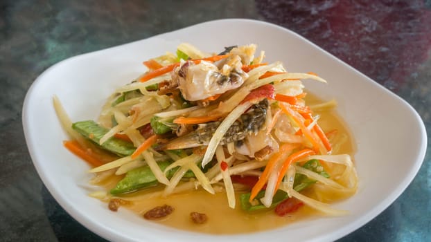 Thai food  spicy papaya salad with pickled brown crab