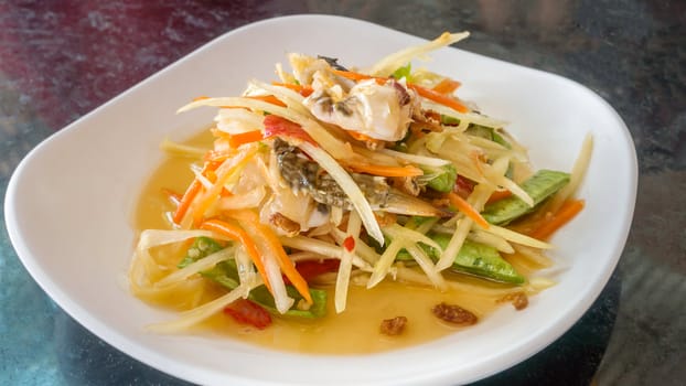 Thai food  spicy papaya salad with pickled brown crab