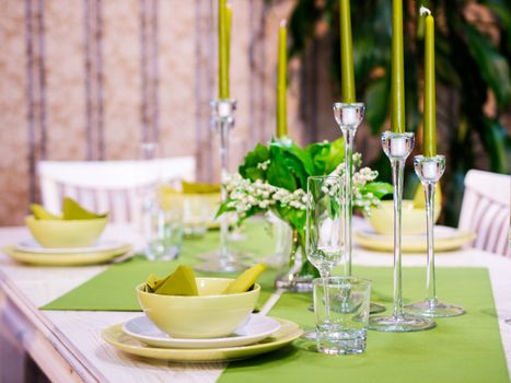 Beautiful table setting with white and green colors. Shallow DOF