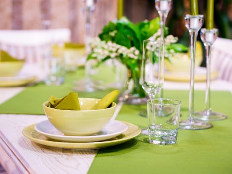 Beautiful table setting with white and green colors. Shallow DOF