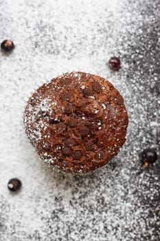 Chocolate cake on a black table with powdered sugar
