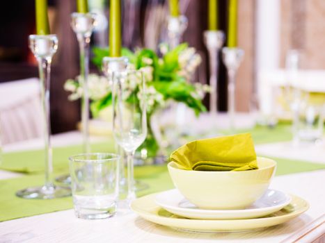 Beautiful table setting with white and green colors. Shallow DOF