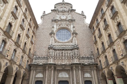 MONTSERRAT, SPAIN - MAY 10, 2016 : Facade of Santa Maria de Montserrat Abbey, Catalonia.Santa Maria de Montserrat  is a Benedictine abbey located on the mountain of Montserrat,  known for the cult statue of Virgin Mary.