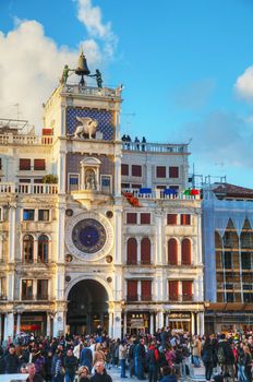 VENICE - NOVEMBER 22: San Marco square with tourists on November 22, 2015 in Venice, Italy. It's the principal public square of Venice, Italy, where it is generally known just as the Piazza.