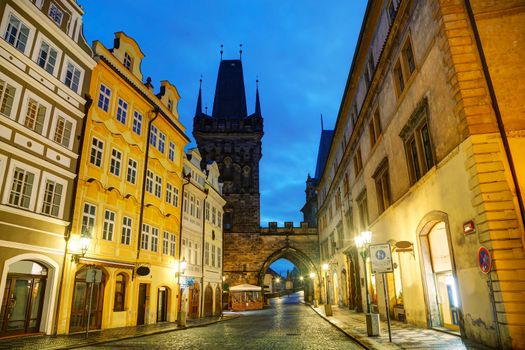 Old Prague street with Charles bridge in the morning