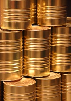 Vertical stack of golden metal food can background