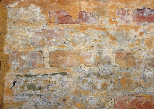 Grunge and worn old yellow brick wall texture
