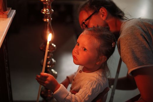 Mother and little daughter in Church