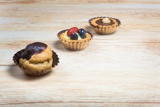 Pictured pastries on light wood background