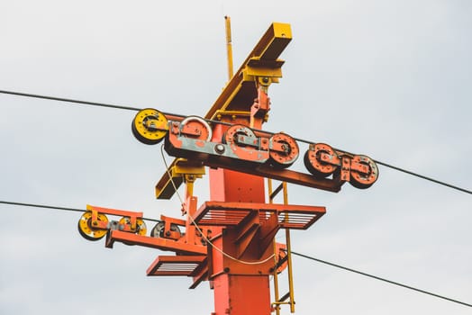 rusty old red yellow ski lift against the sky