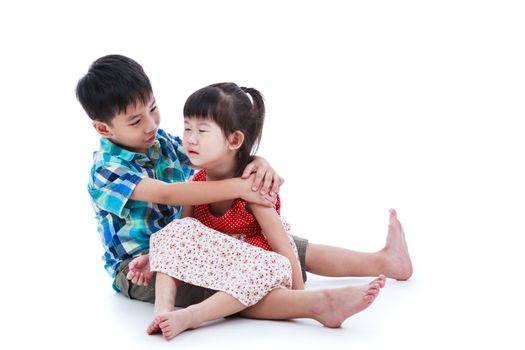 Full body. Elder brother is comforting his crying sister, girl sitting on lap and feel bad. Isolated on white background. Conceptual about familial love.