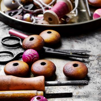 Wood beads jewelry and tool for making iron on vintage background