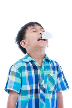 Asian boy using tissue to wipe snot from his nose. Child with allergy symptom. Isolated on white background. Negative human emotion, facial expression feeling reaction. Studio shot.